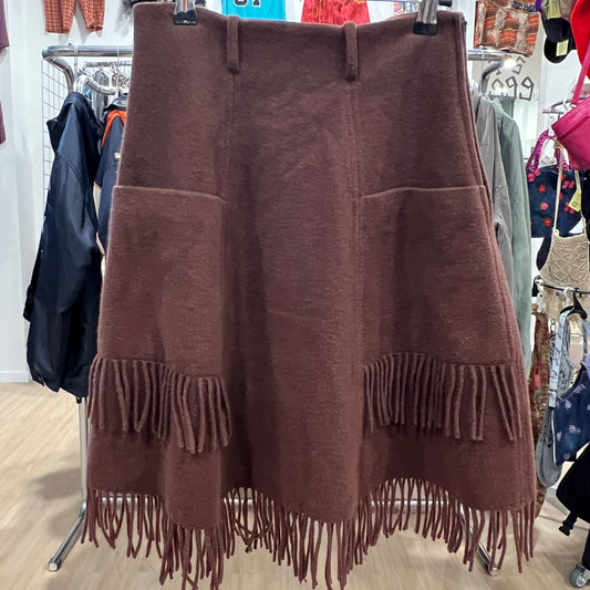 Brown fringed skirt on a rack in a store setting