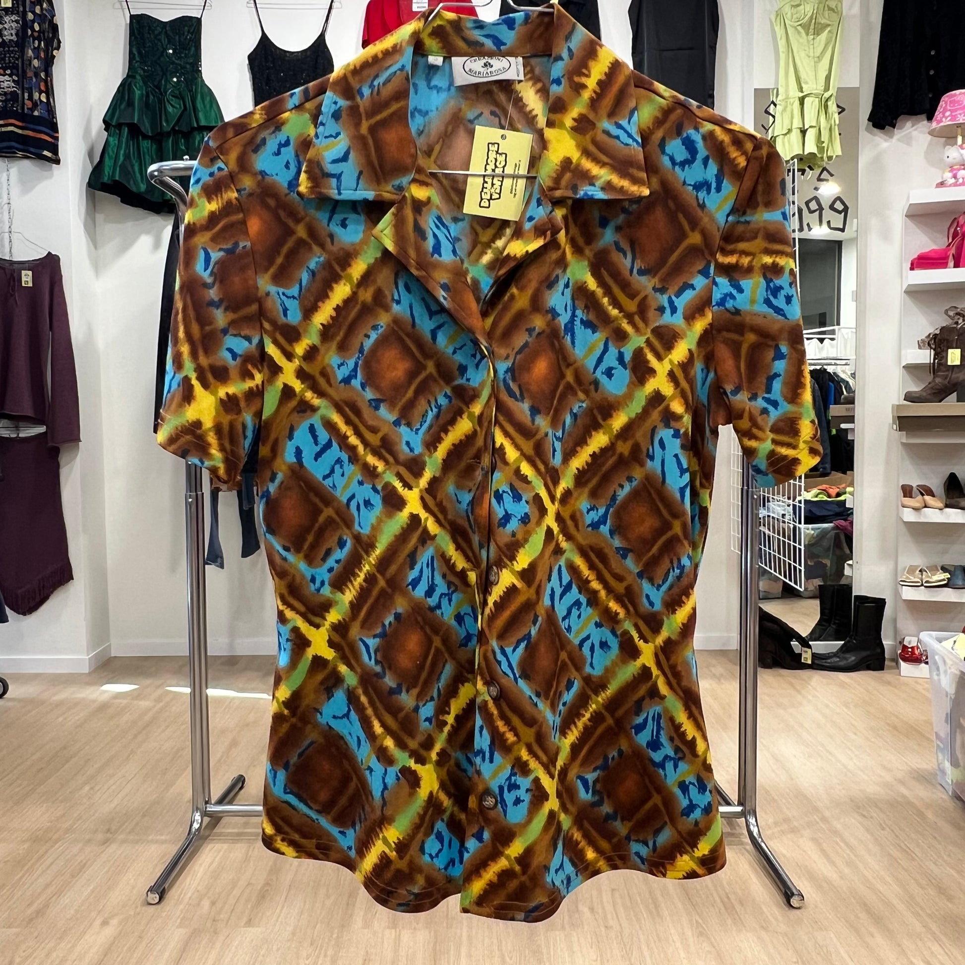 Colorful patterned shirt on a hanger in a store setting