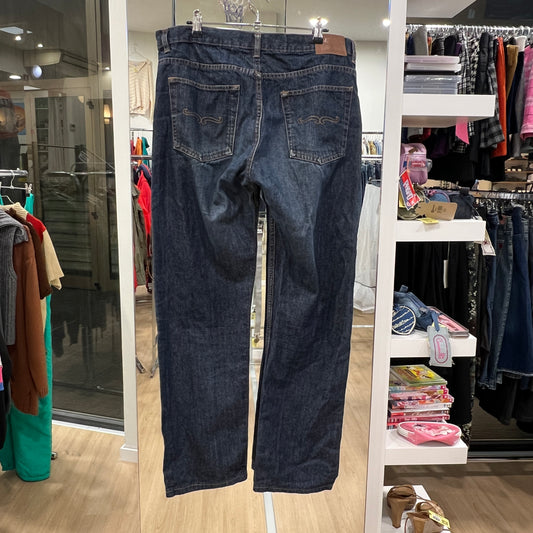Pair of blue jeans hanging on a rack in a store setting