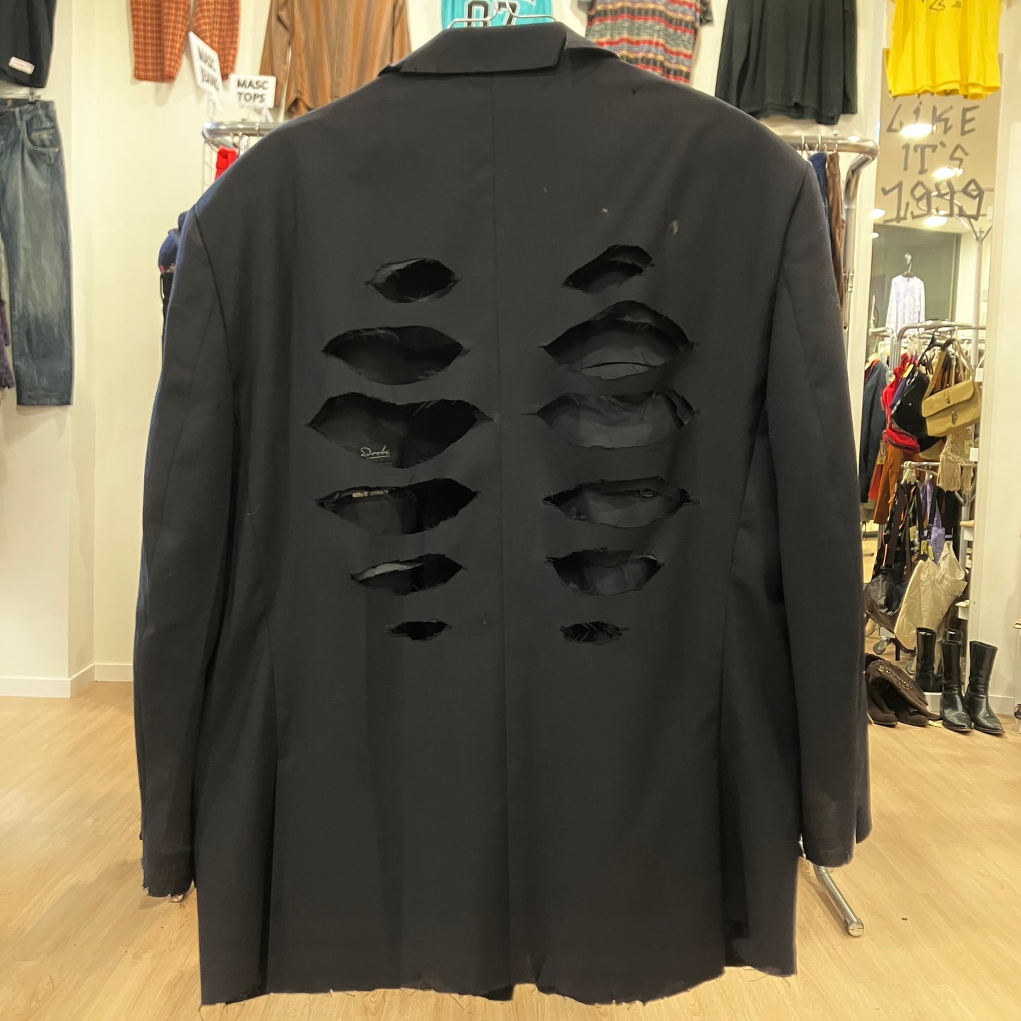 Black distressed jacket in a store setting