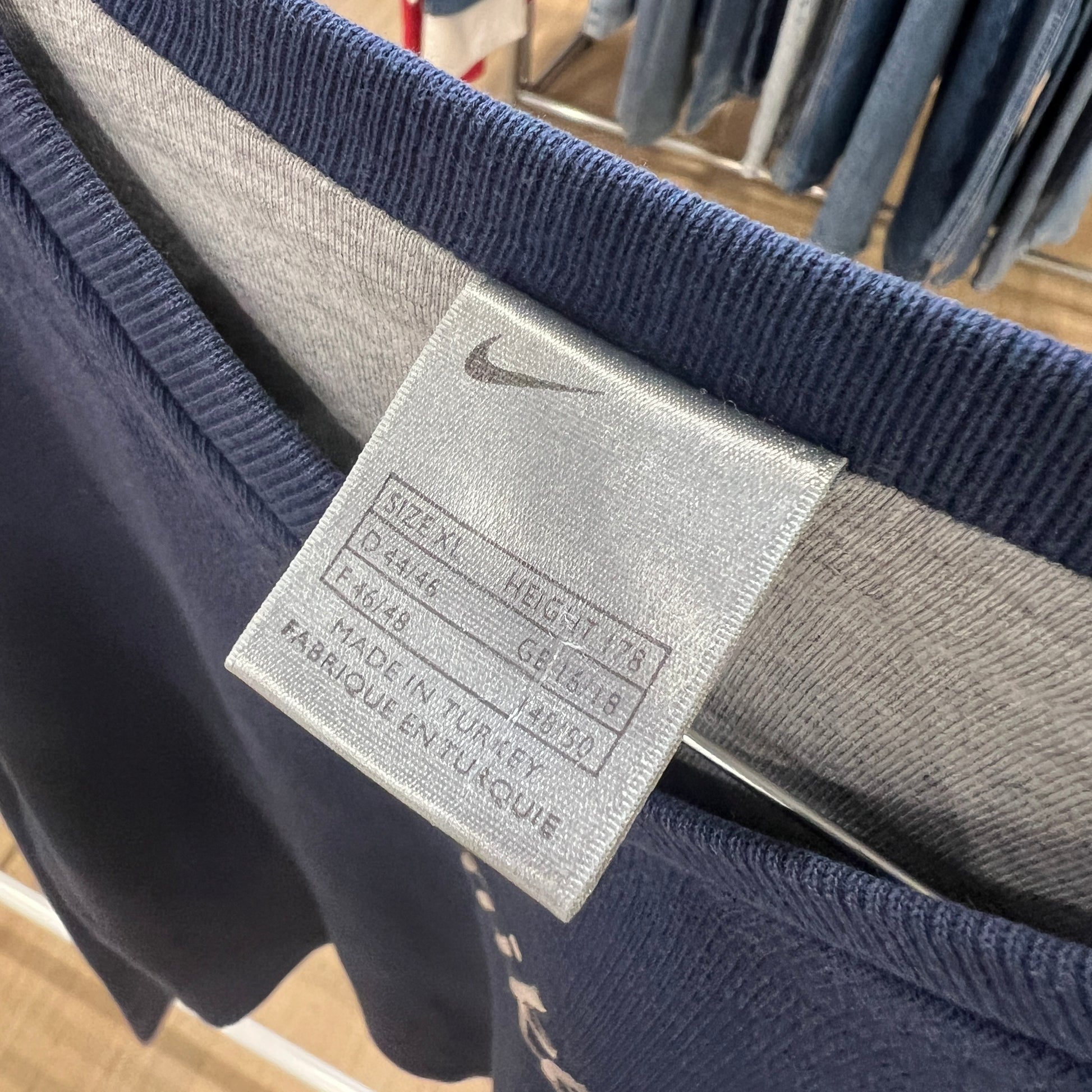 Close-up of a Nike tag on a piece of clothing with a blurred background