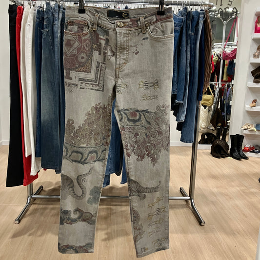 Patterned jeans hanging on a rack in a store setting