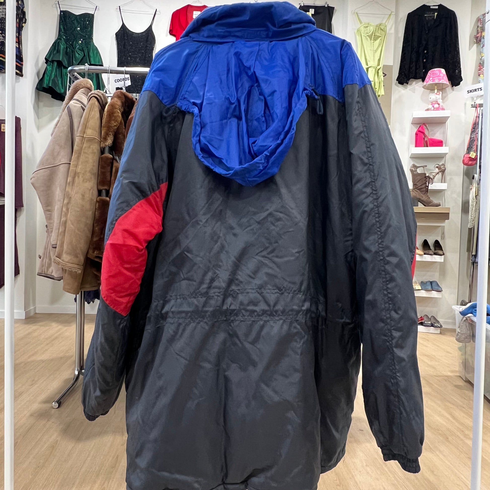 Black and blue jacket with red sleeve in a clothing store