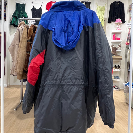 Black and blue jacket with red sleeve in a clothing store