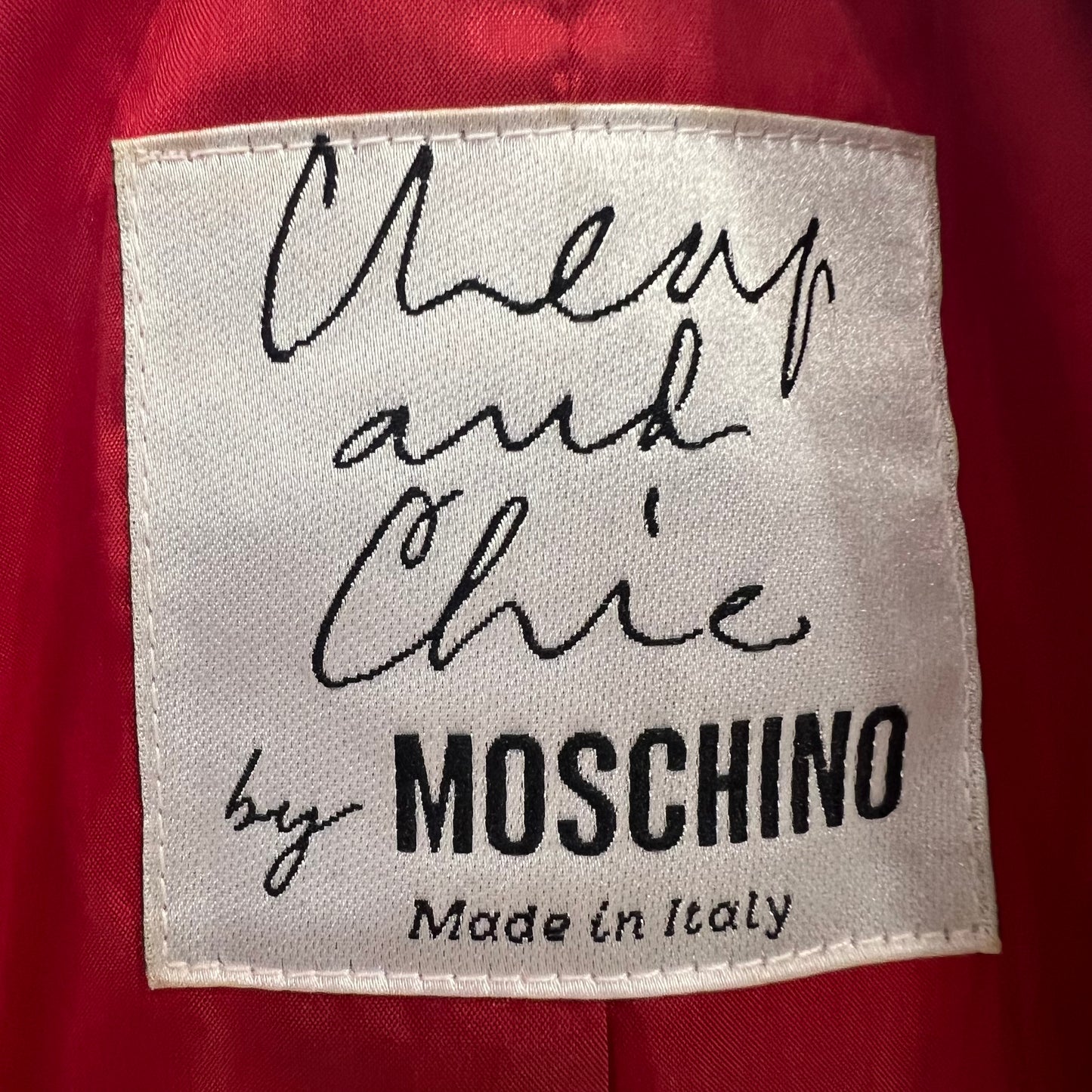 Label with 'Cheap and Chic by Moschino Made in Italy' text on a red background