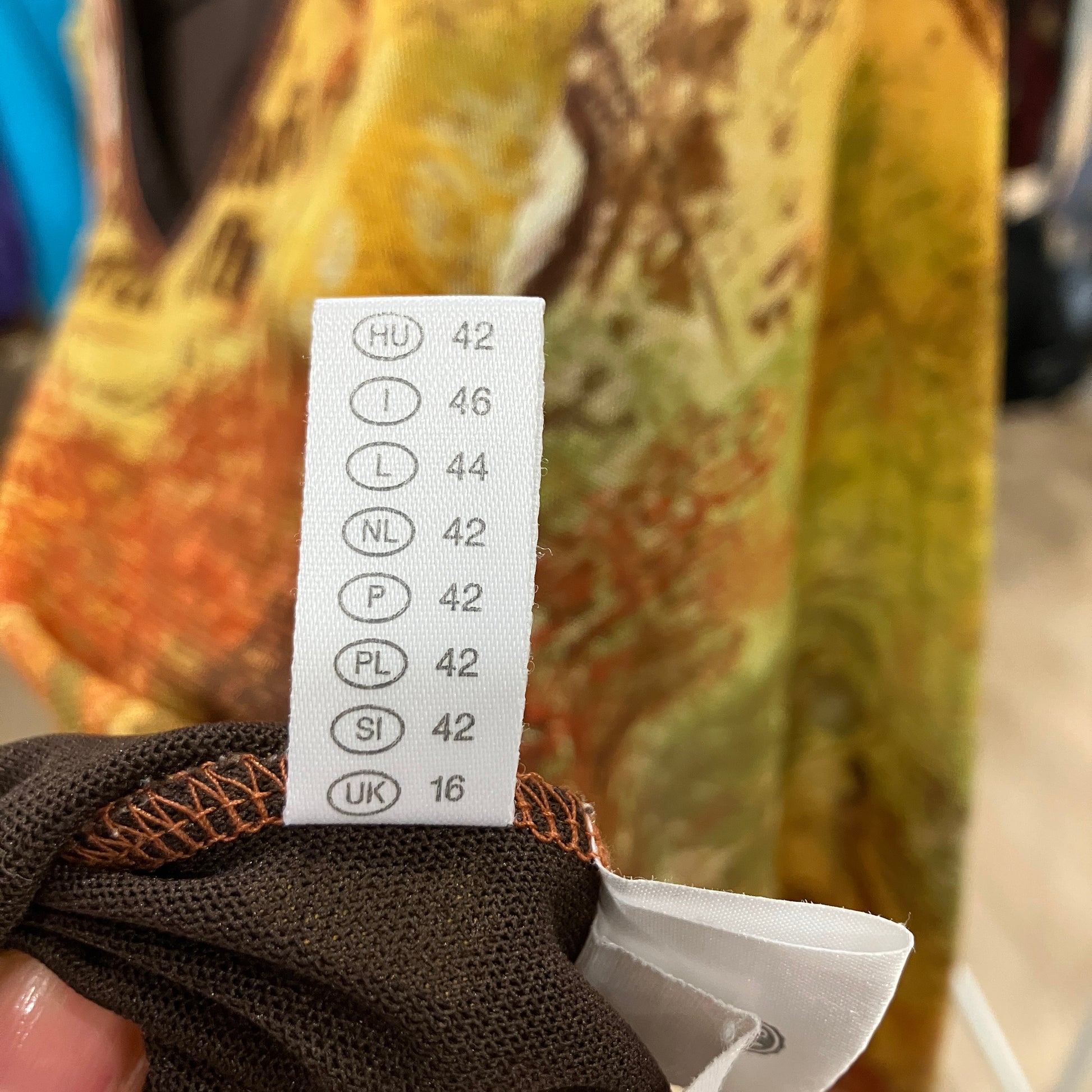 Size label on a piece of clothing with a blurred background