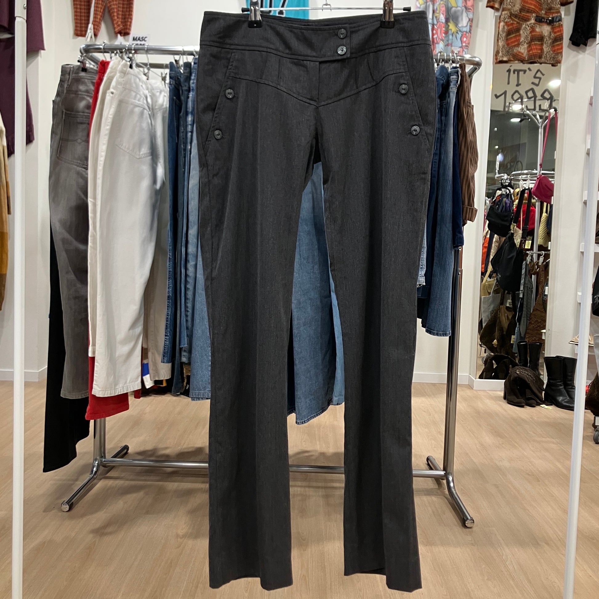Black pants hanging on a rack in a clothing store