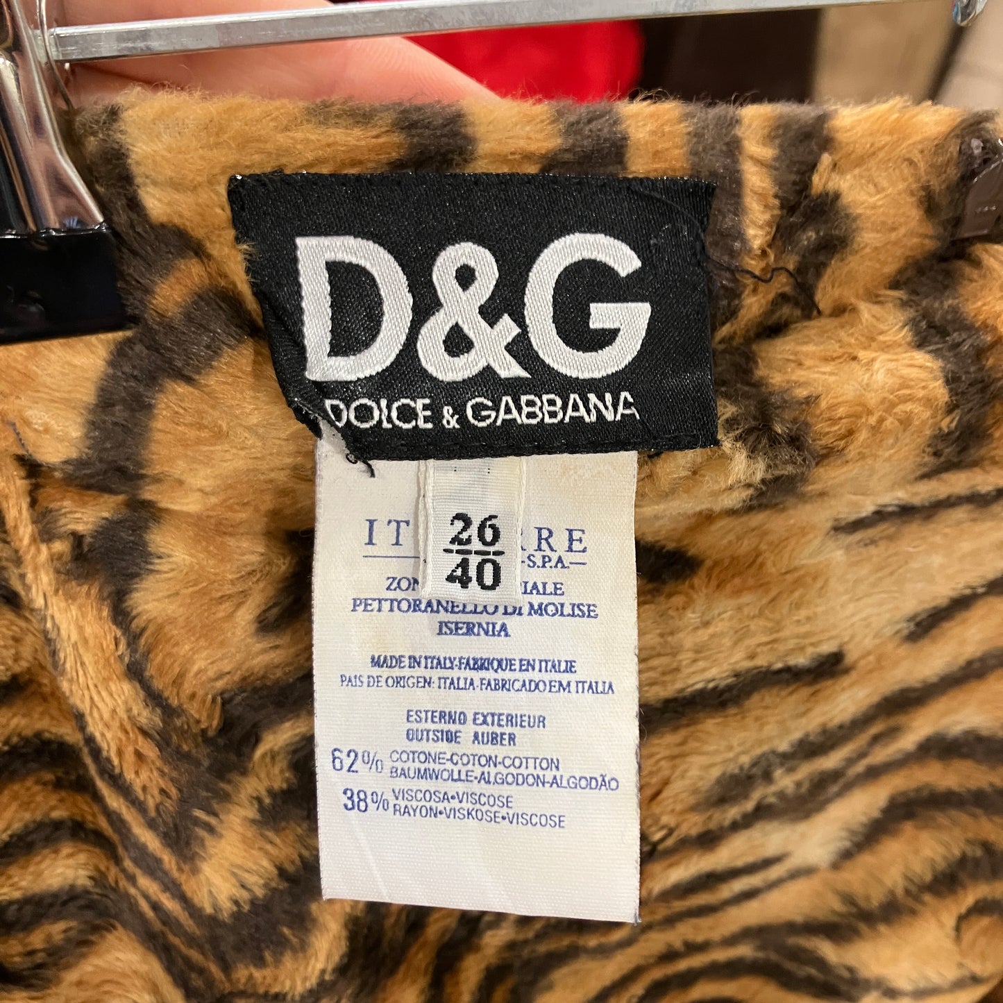 Dolce & Gabbana label on a tiger-striped fabric background