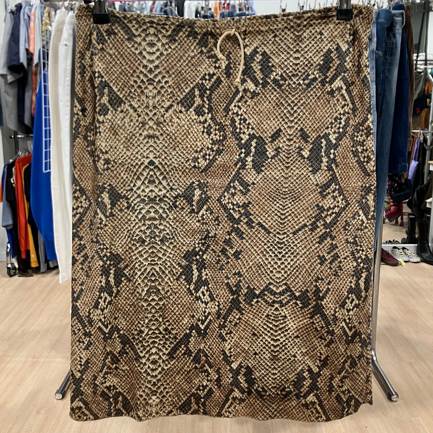 Snakeskin patterned fabric on a hanger in a store setting