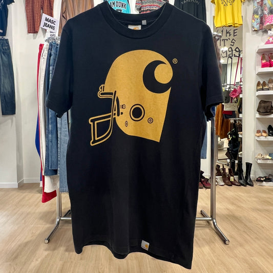 Black t-shirt with a yellow logo in a store setting