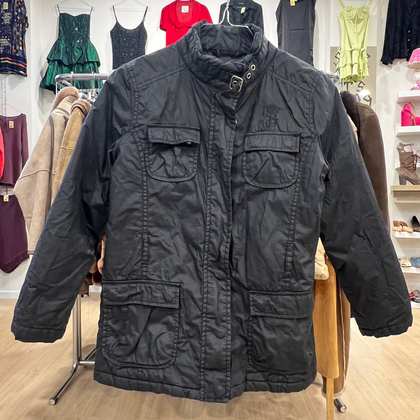 Black jacket on a hanger with a clothing store background