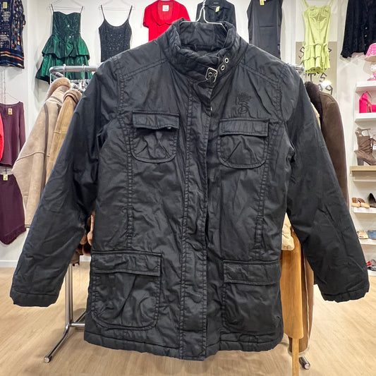 Black jacket on a hanger with a clothing store background