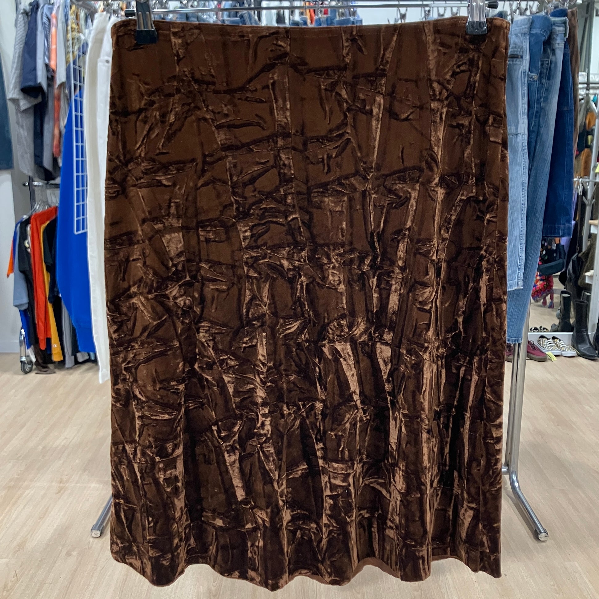 Brown textured fabric on a rack in a store setting