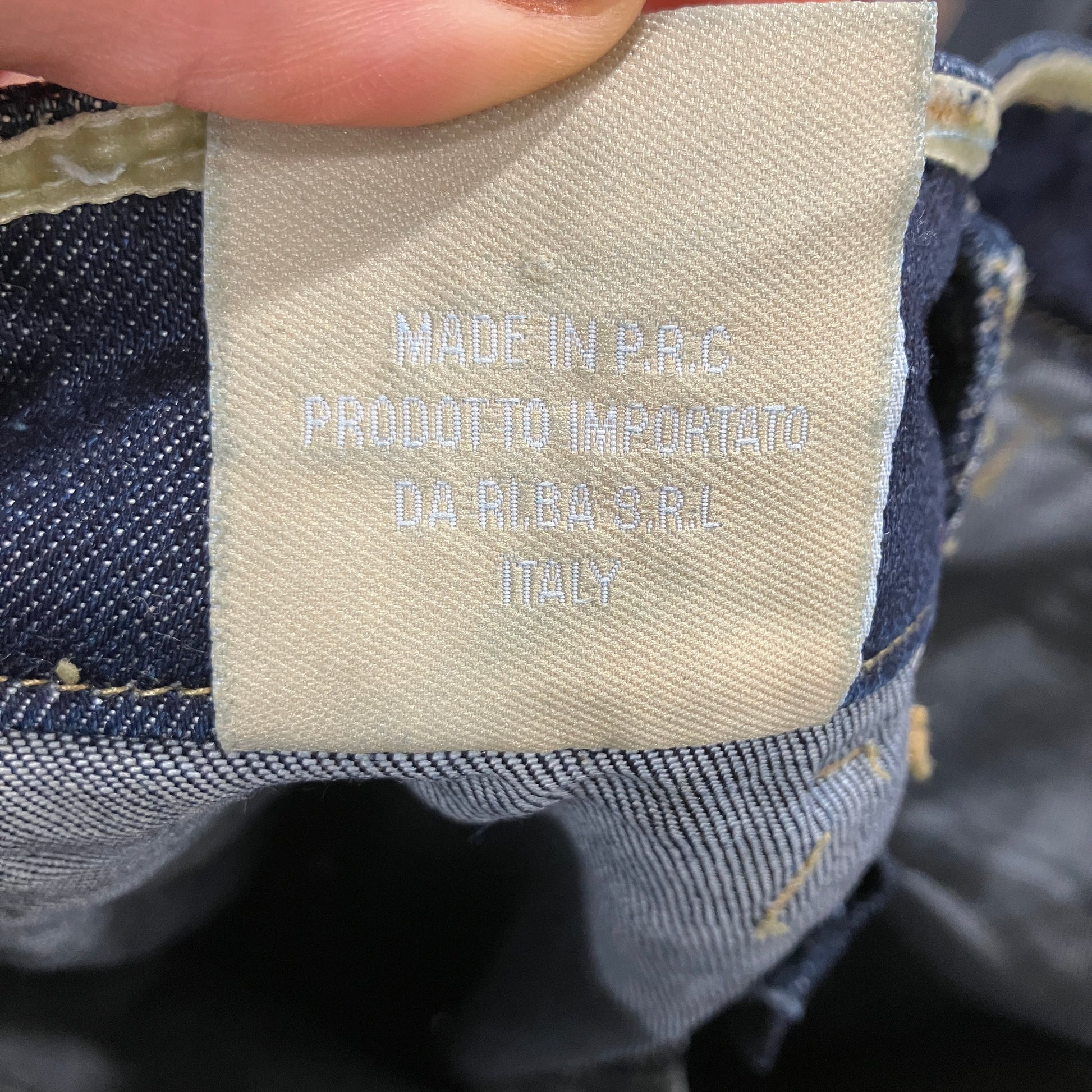 Label on denim fabric indicating 'Made in P.R.C.' with additional text