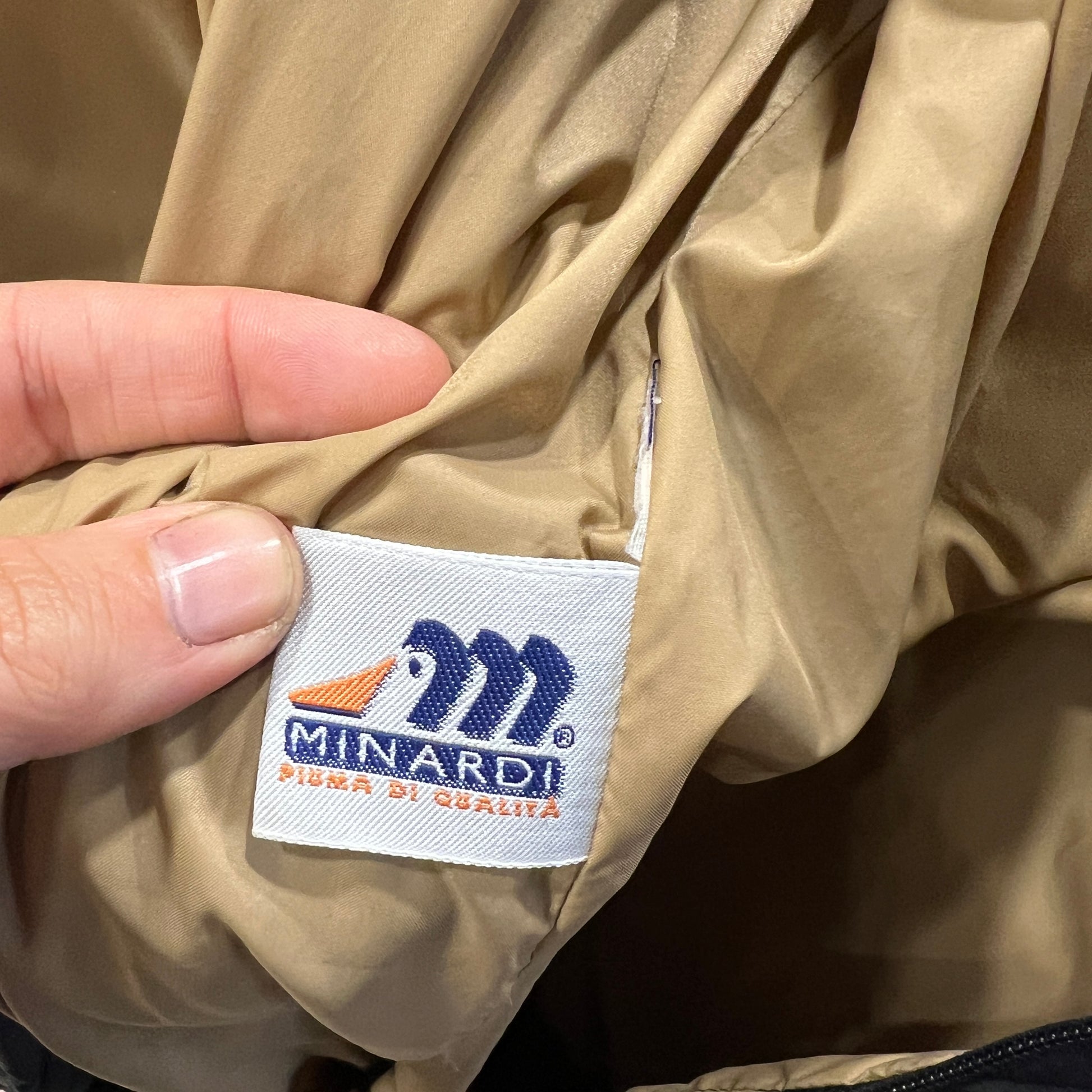 Minardi logo on a beige jacket label