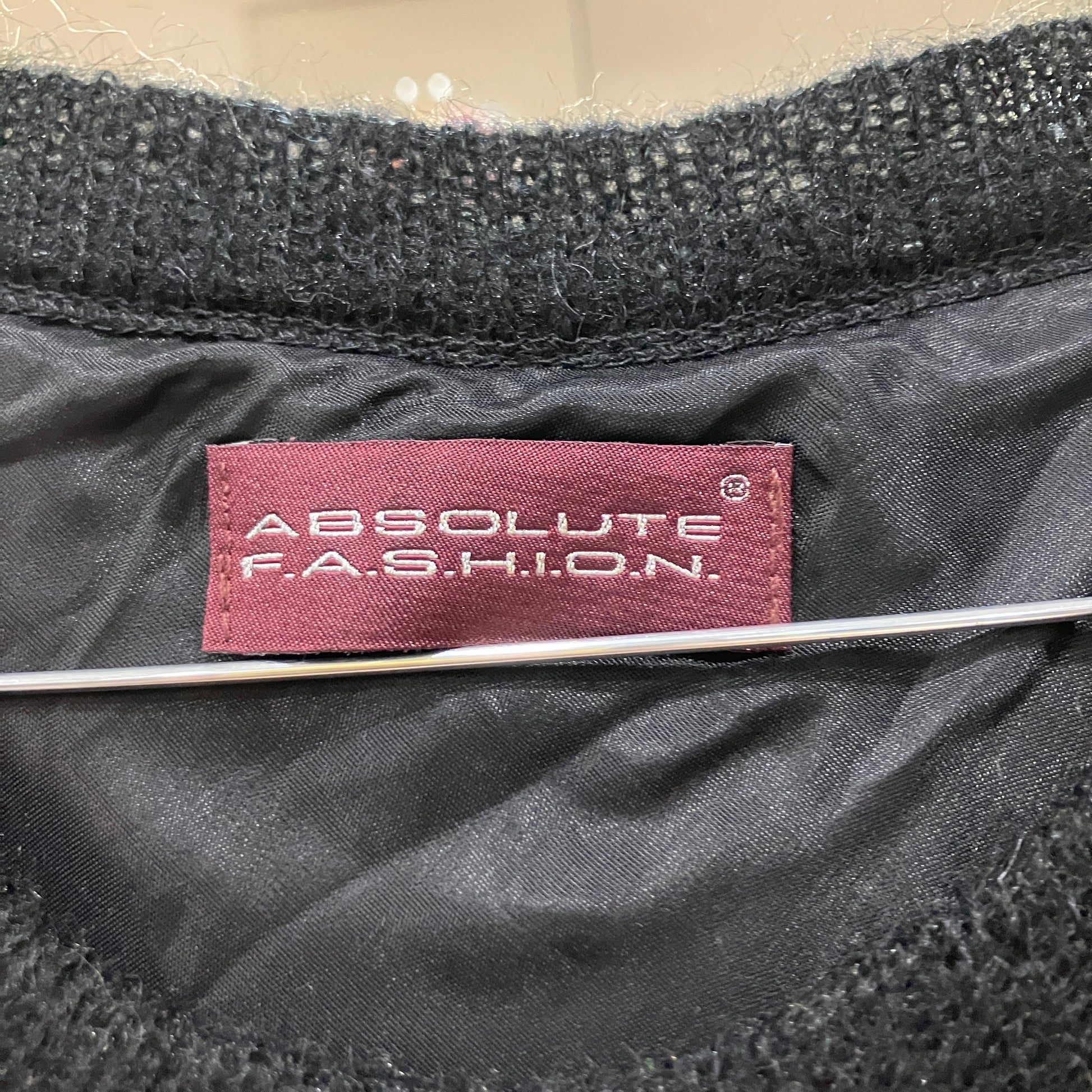 Black fabric with a 'Absolute F.A.S.H.I.O.N.' label