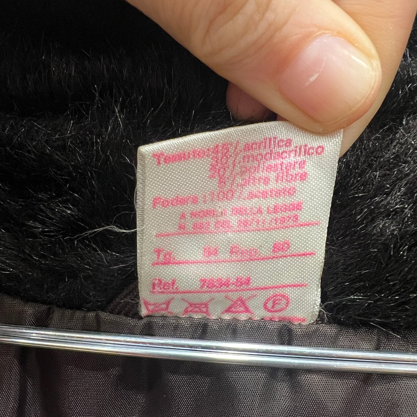 Close-up of a fabric label on black material