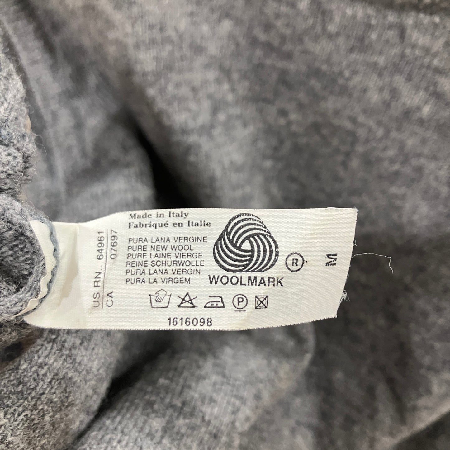 Woolmark label on a gray fabric background