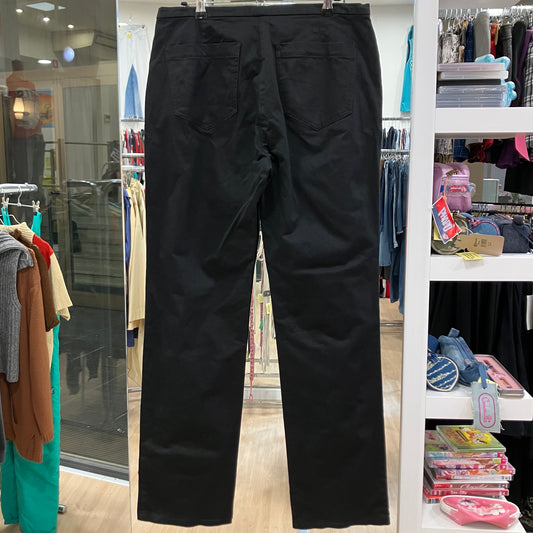 Black pants hanging on a rack in a store setting