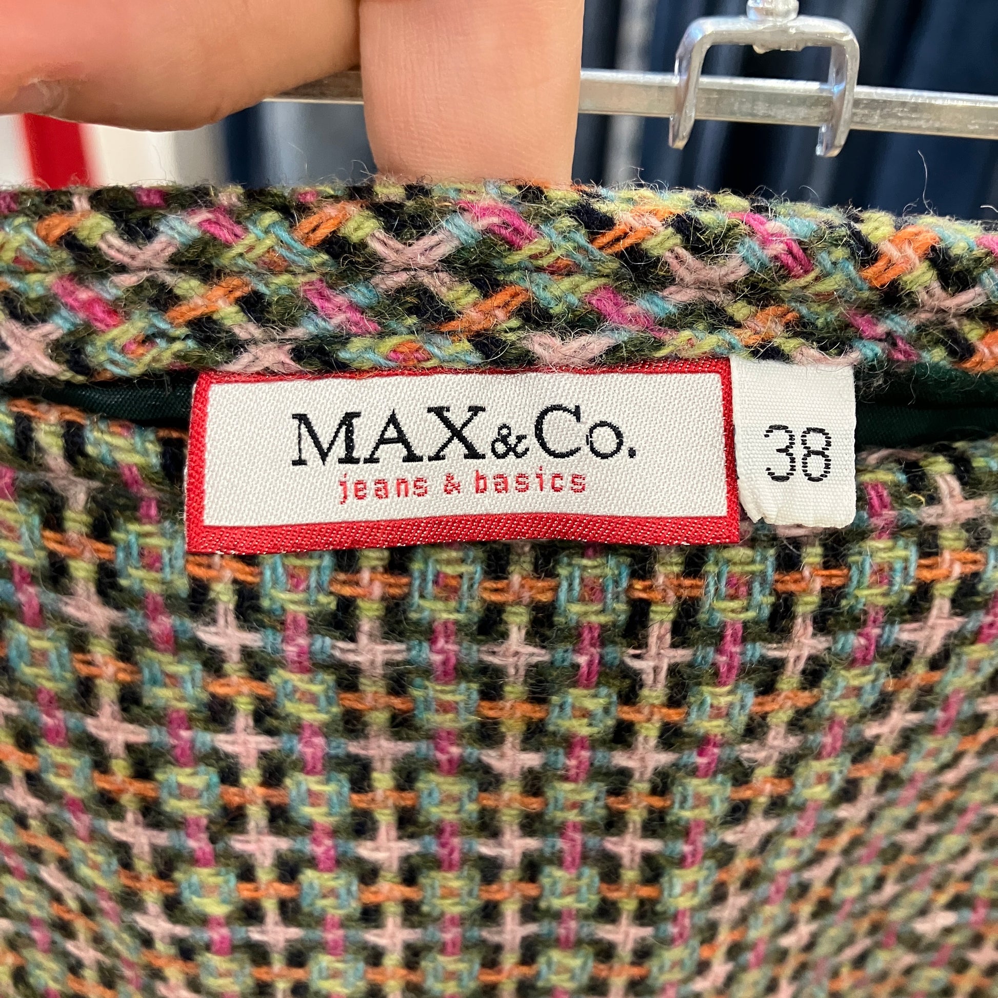 Close-up of a multicolored fabric with a MAX & Co. label and size tag