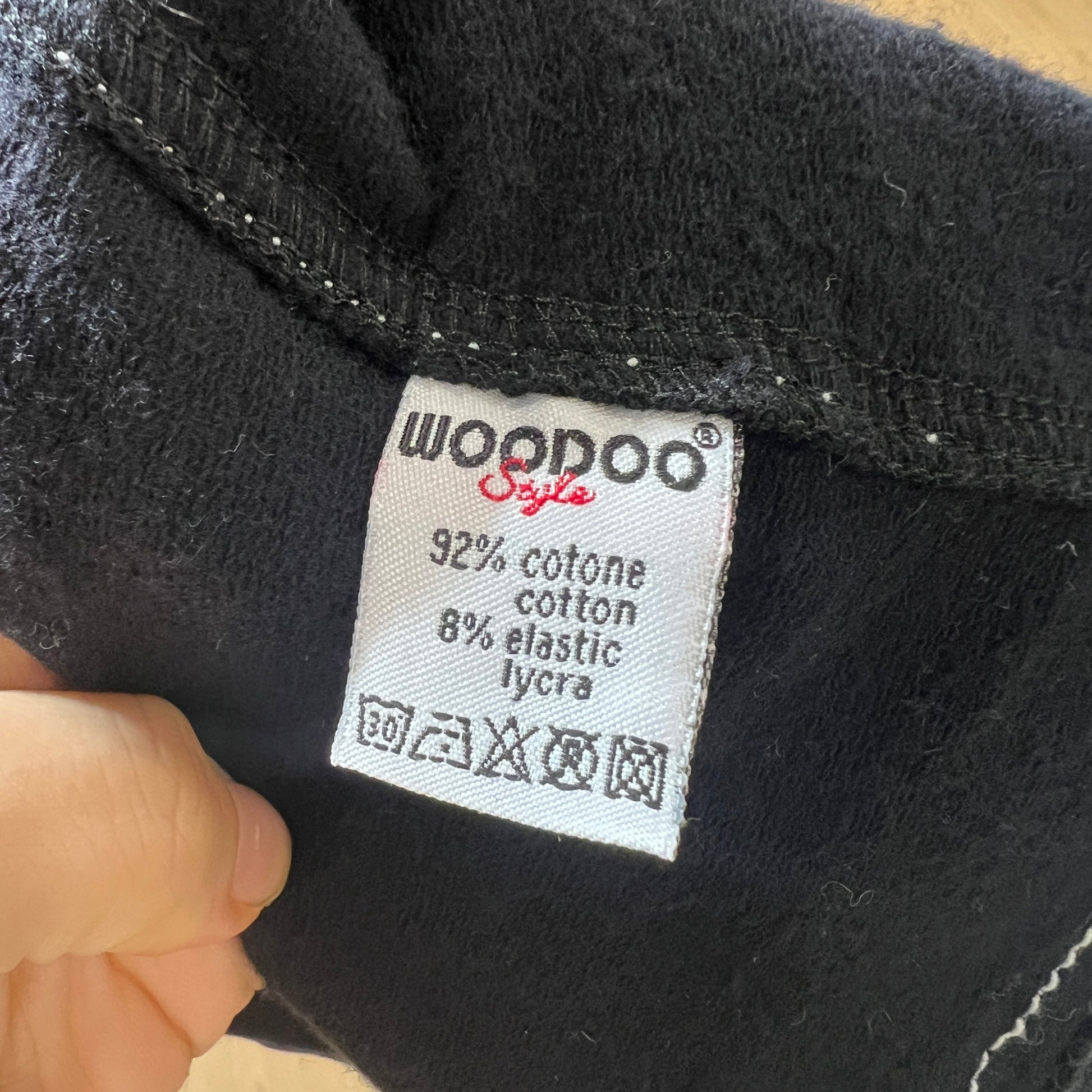 Black fabric with a 'Woodoo Style' label showing material composition