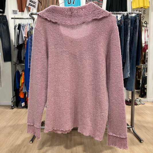 Pink sweater on a rack in a clothing store