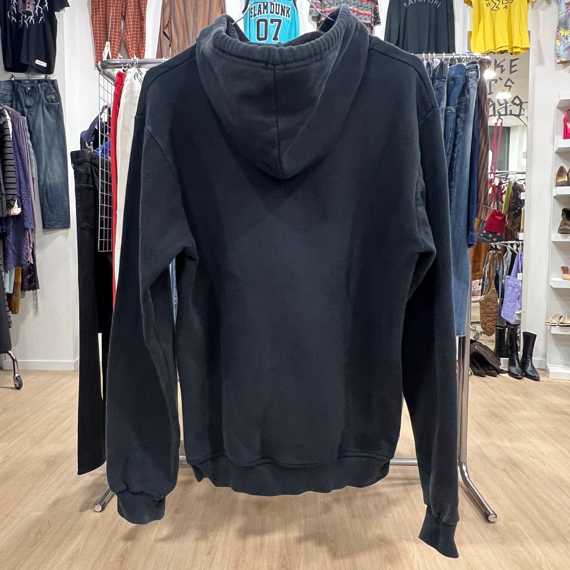 Black hoodie on a rack in a clothing store