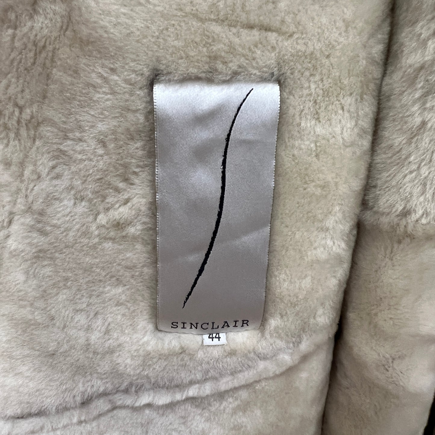 Close-up of a Sinclair label on a textured fabric background