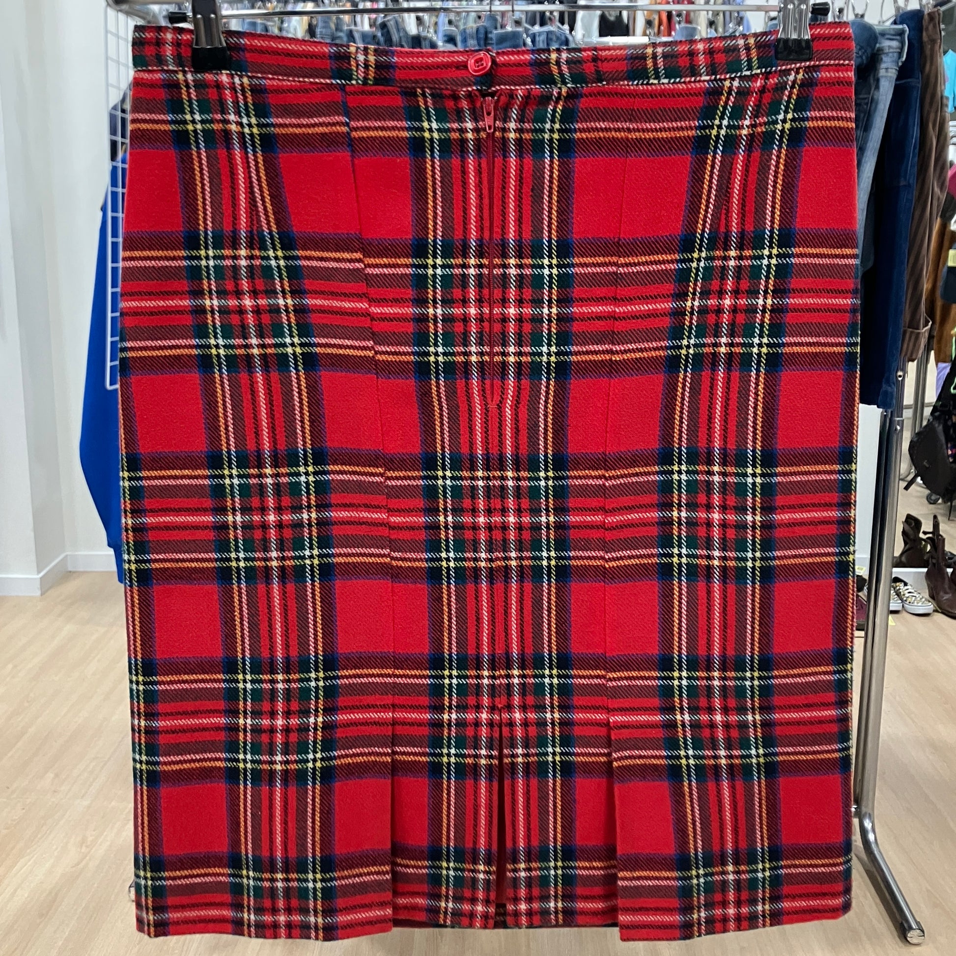Red plaid skirt on a rack in a store setting