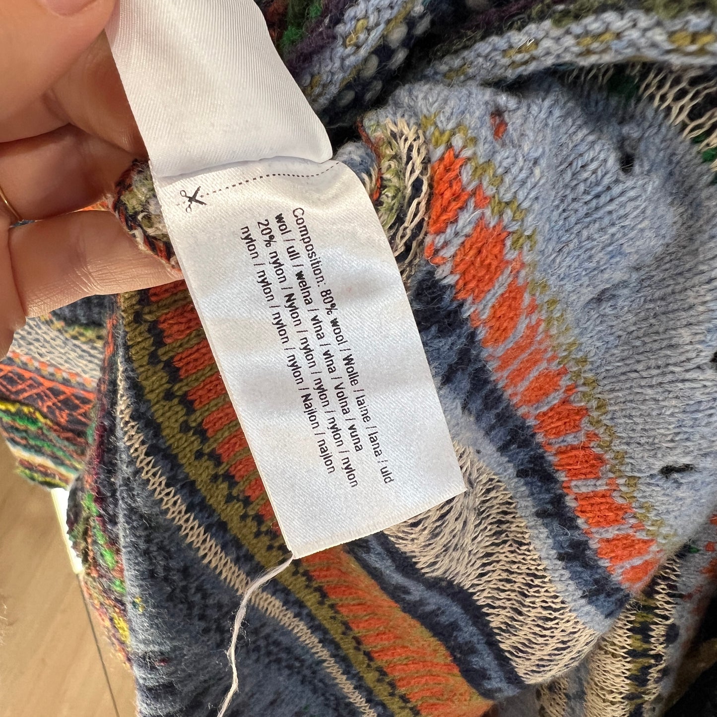 Close-up of a colorful fabric with a label on a textured surface