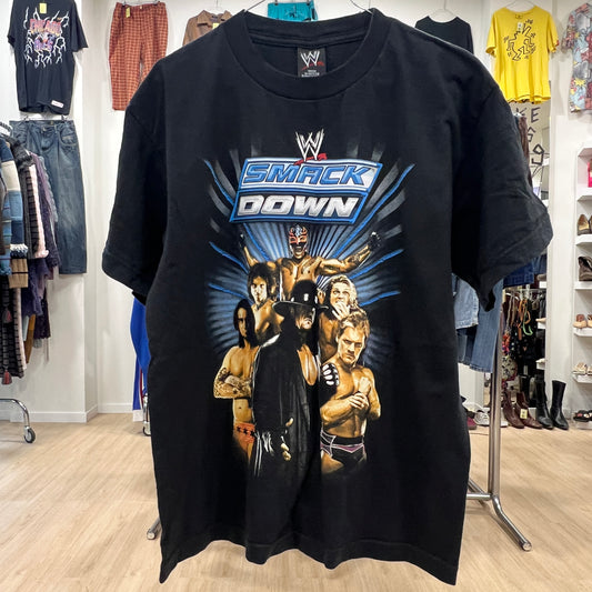 Black t-shirt with WWE SmackDown graphic in a store setting