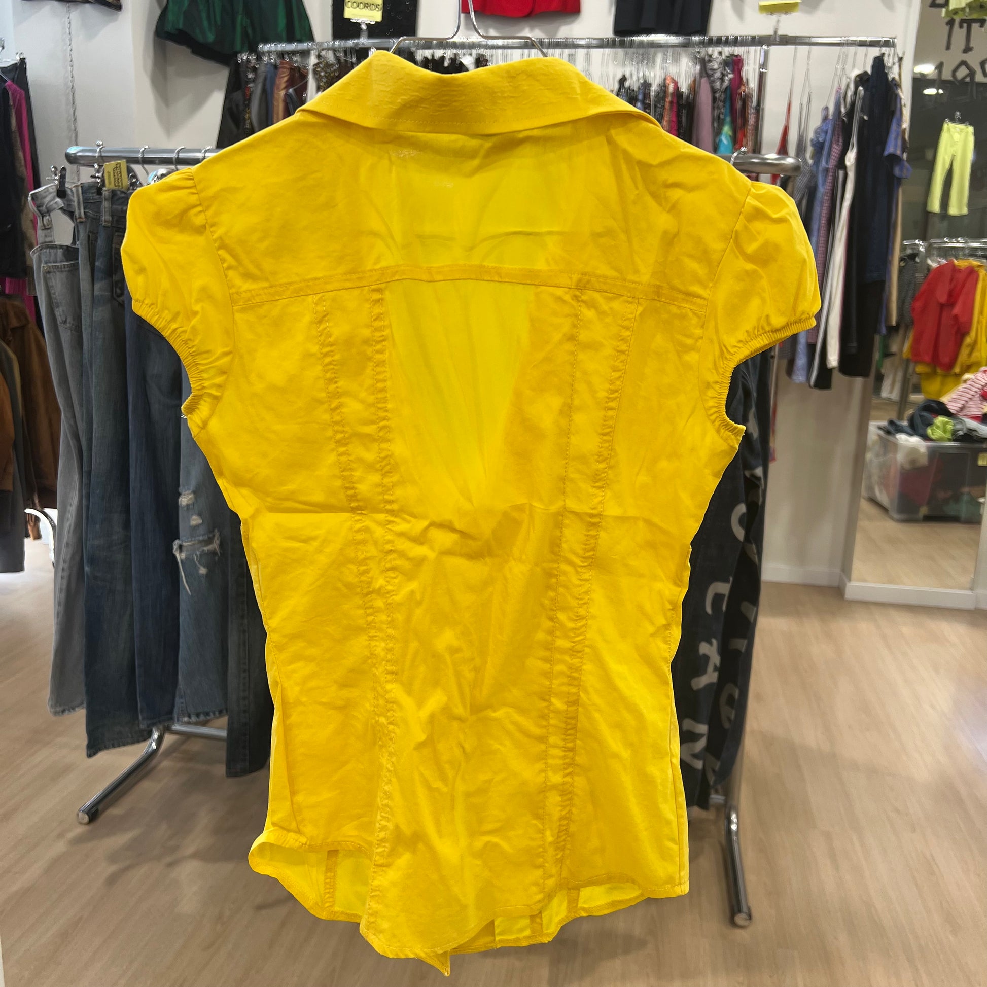 Yellow shirt on a rack in a clothing store
