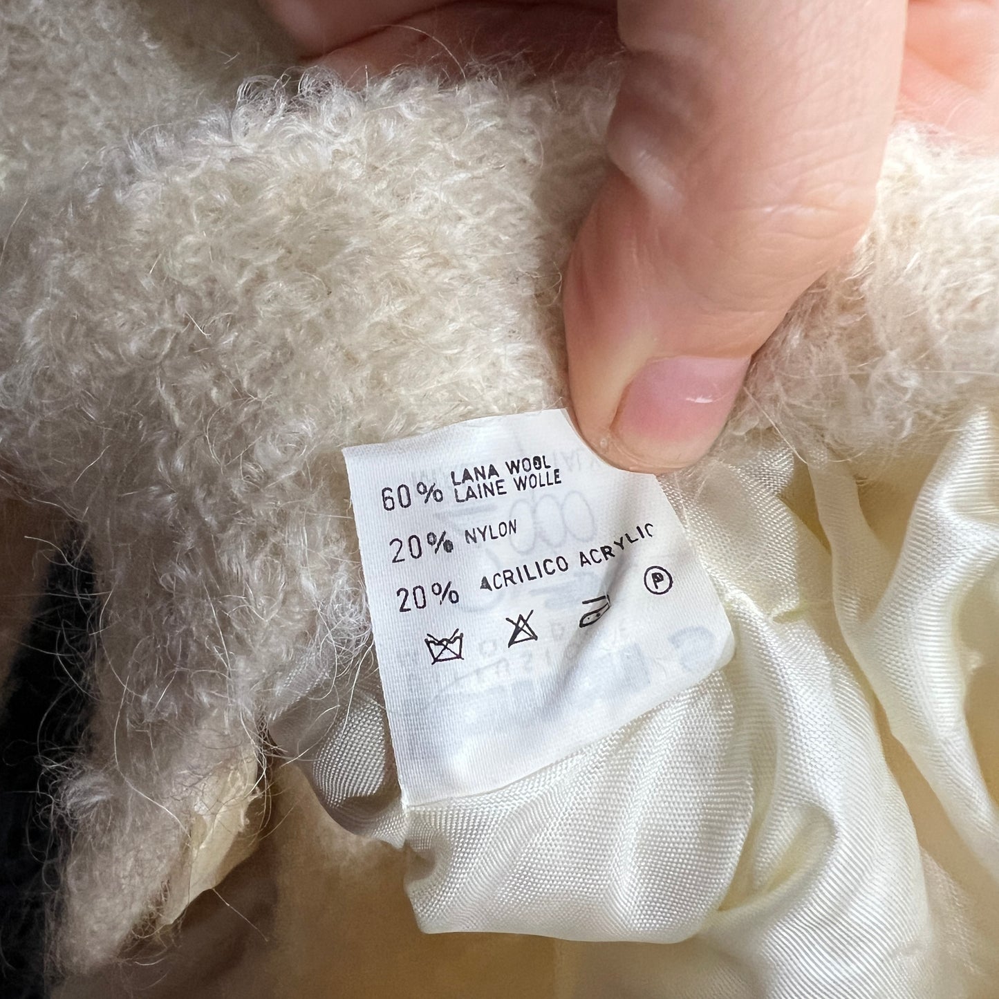 Close-up of a fabric label on a textured white fabric