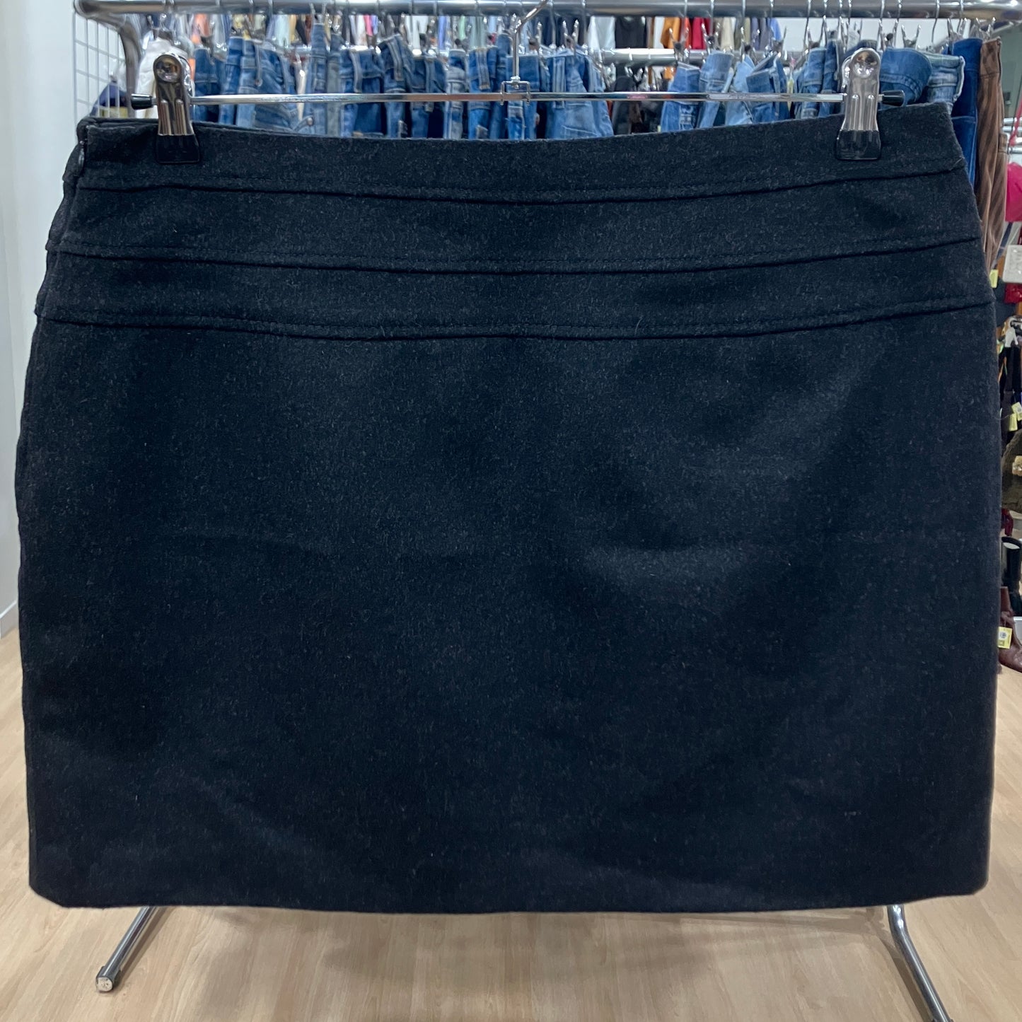 Black skirt on a hanger with jeans in the background