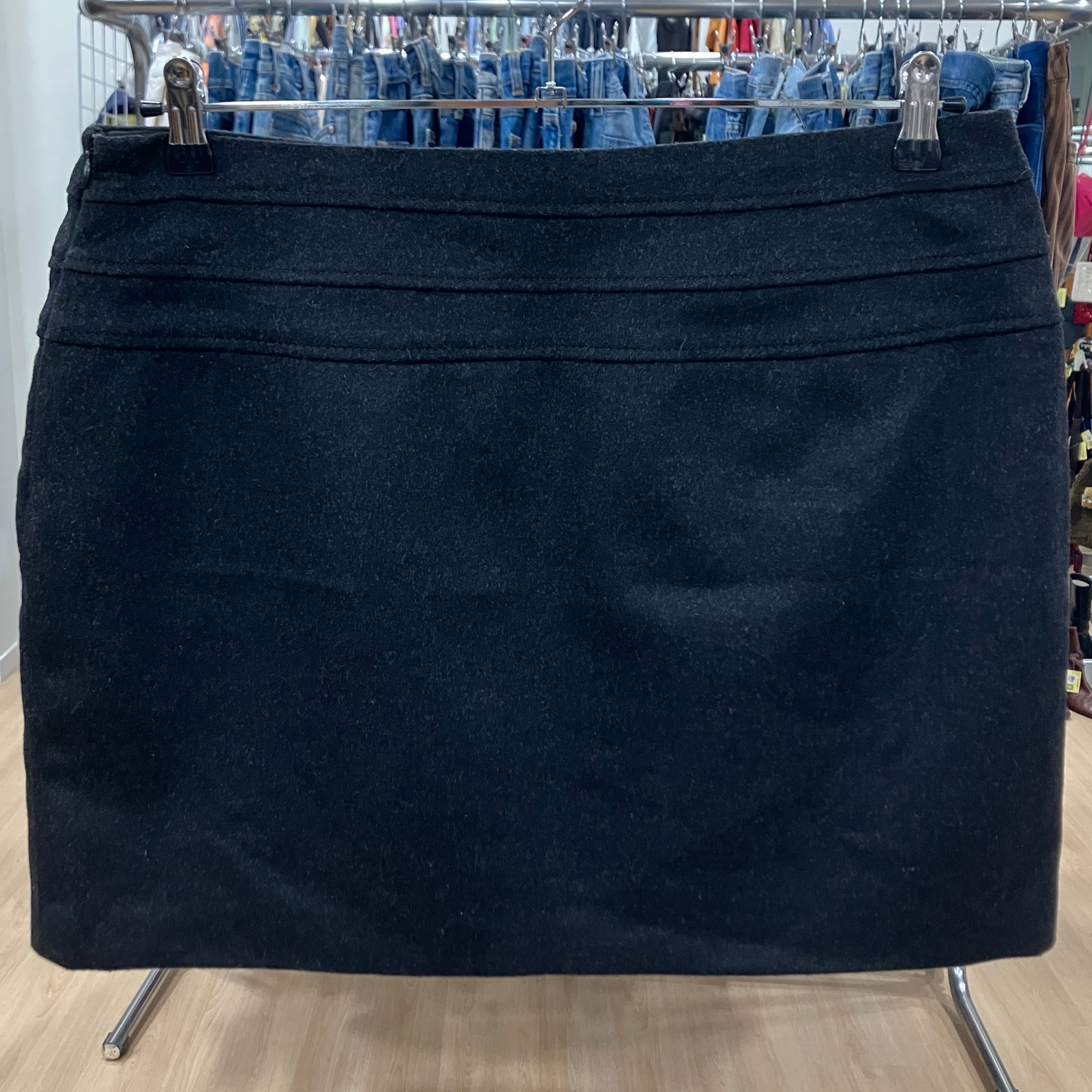 Black skirt on a hanger with jeans in the background