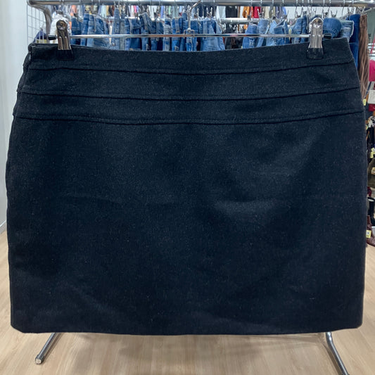 Black skirt on a hanger with jeans in the background