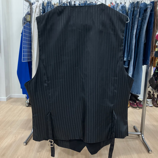 Black pinstripe vest on a rack with jeans in the background