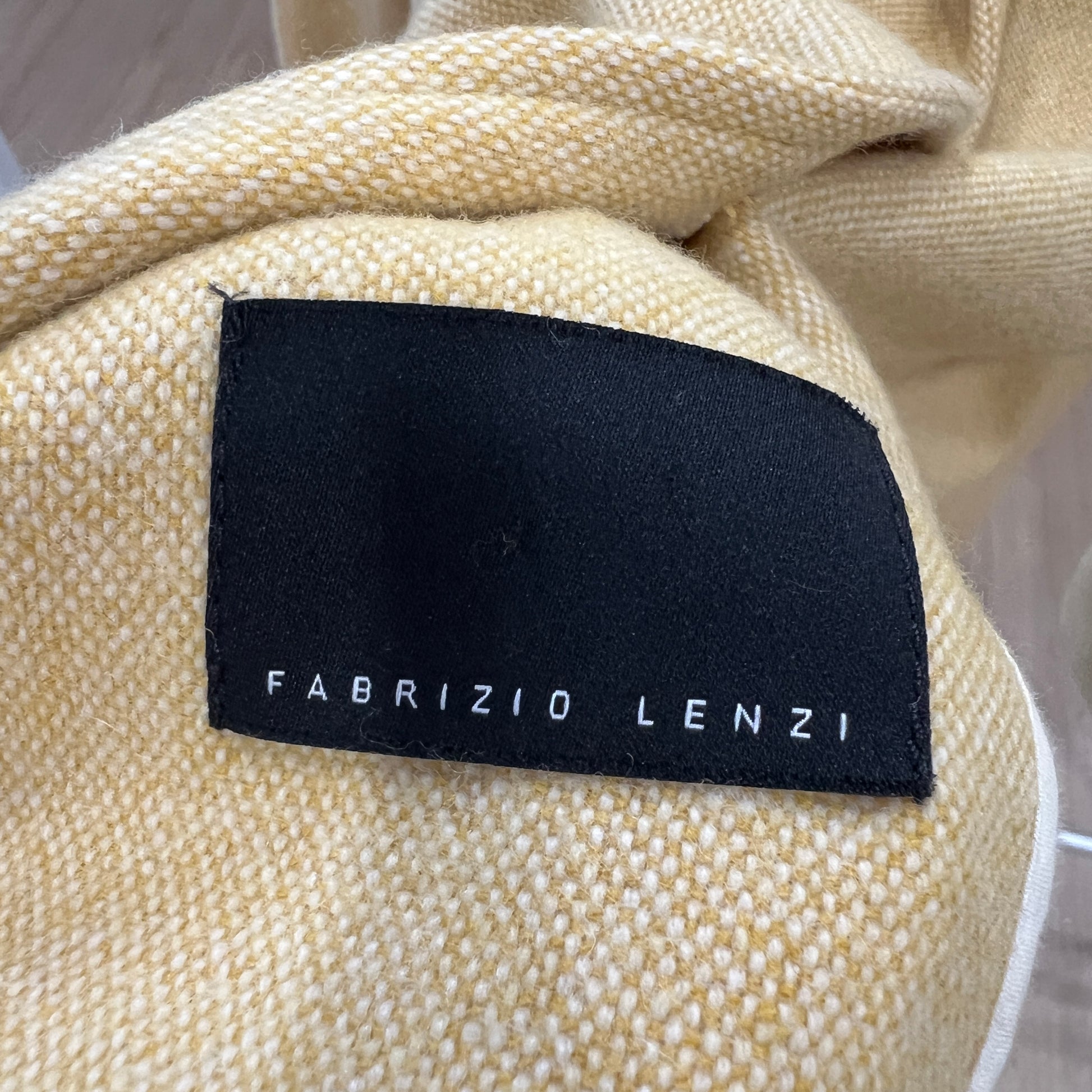 Beige fabric with a black label reading 'Fabrizio Lenzi' 