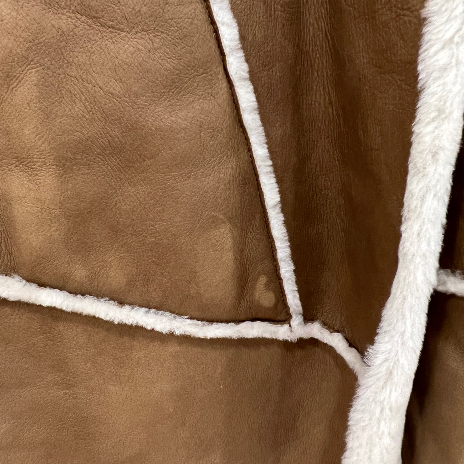 Close-up of brown leather with white stitching