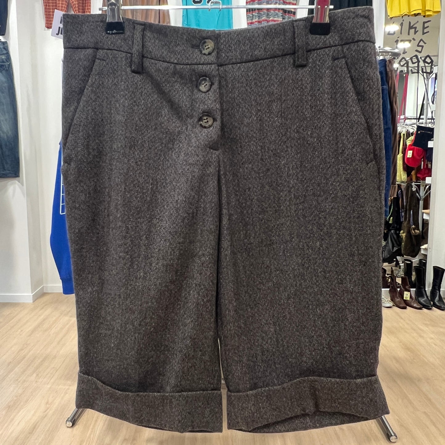 Gray textured shorts on a hanger with a store background