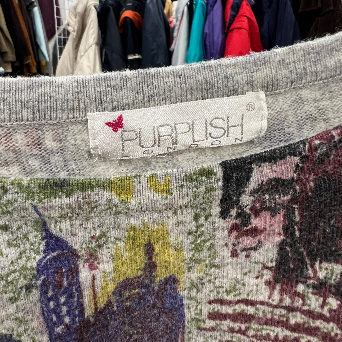 Textile with 'PURPLISH' label in a clothing store setting