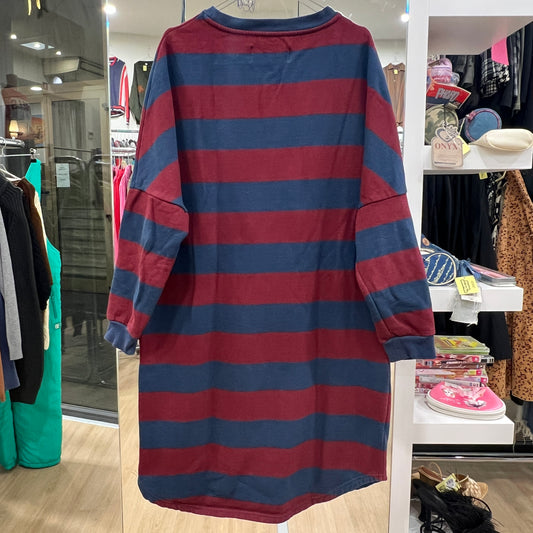 Red and blue striped dress hanging in a store