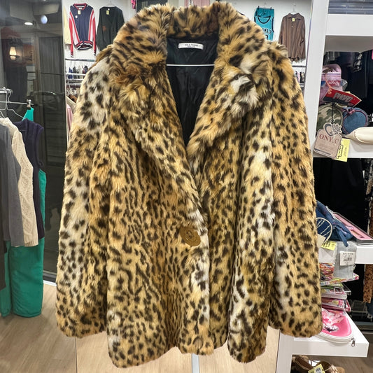 Leopard print fur coat in a store setting with clothing racks and products in the background