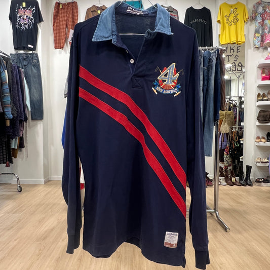 Navy long-sleeve polo shirt with red stripes and logo in a clothing store