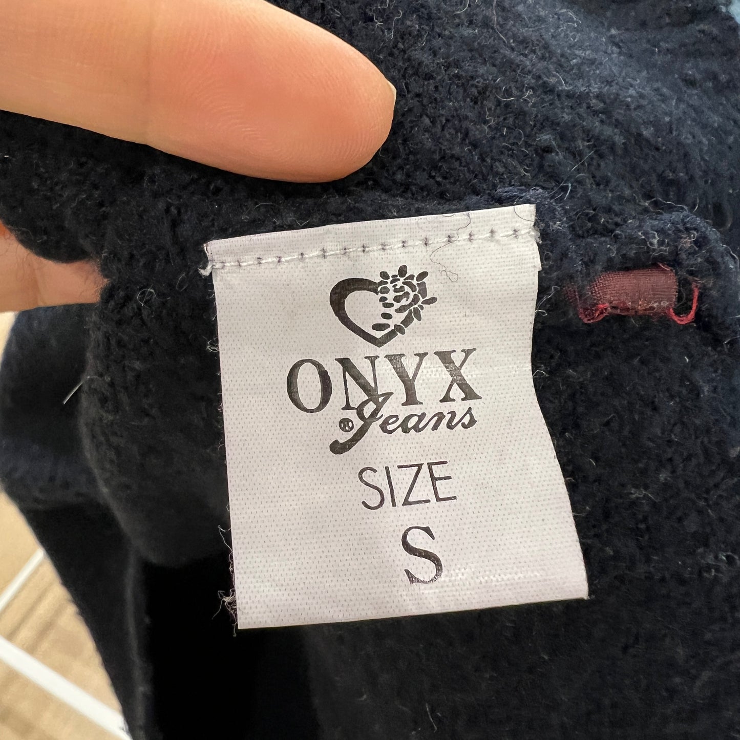 Onyx Jeans size label on a black garment