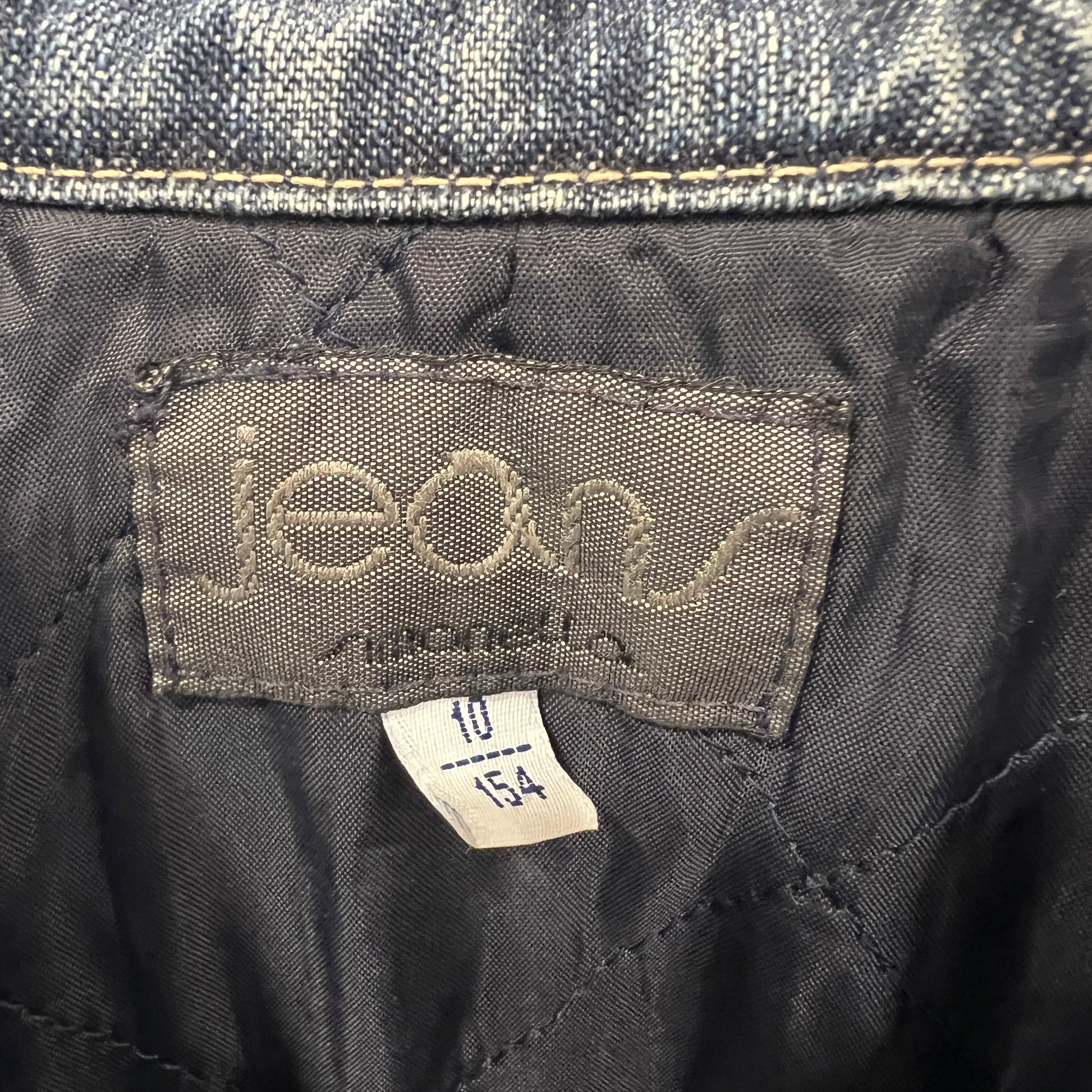 Close-up of a denim label on a pair of jeans with 'jeans' text