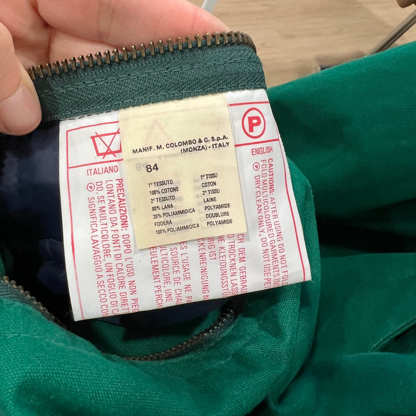 Close-up of a green jacket label with text and symbols