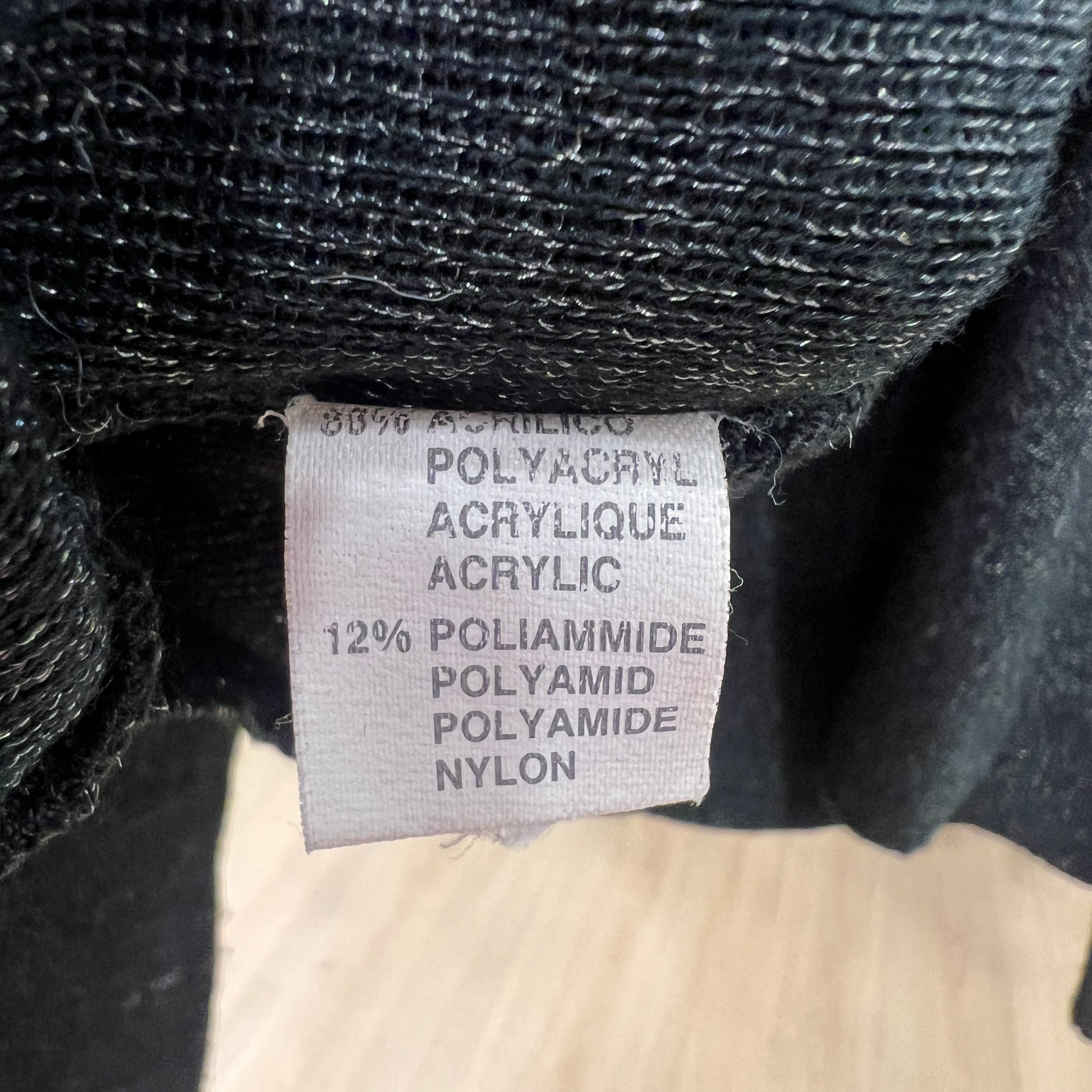 Textile label on a black fabric with fiber content details
