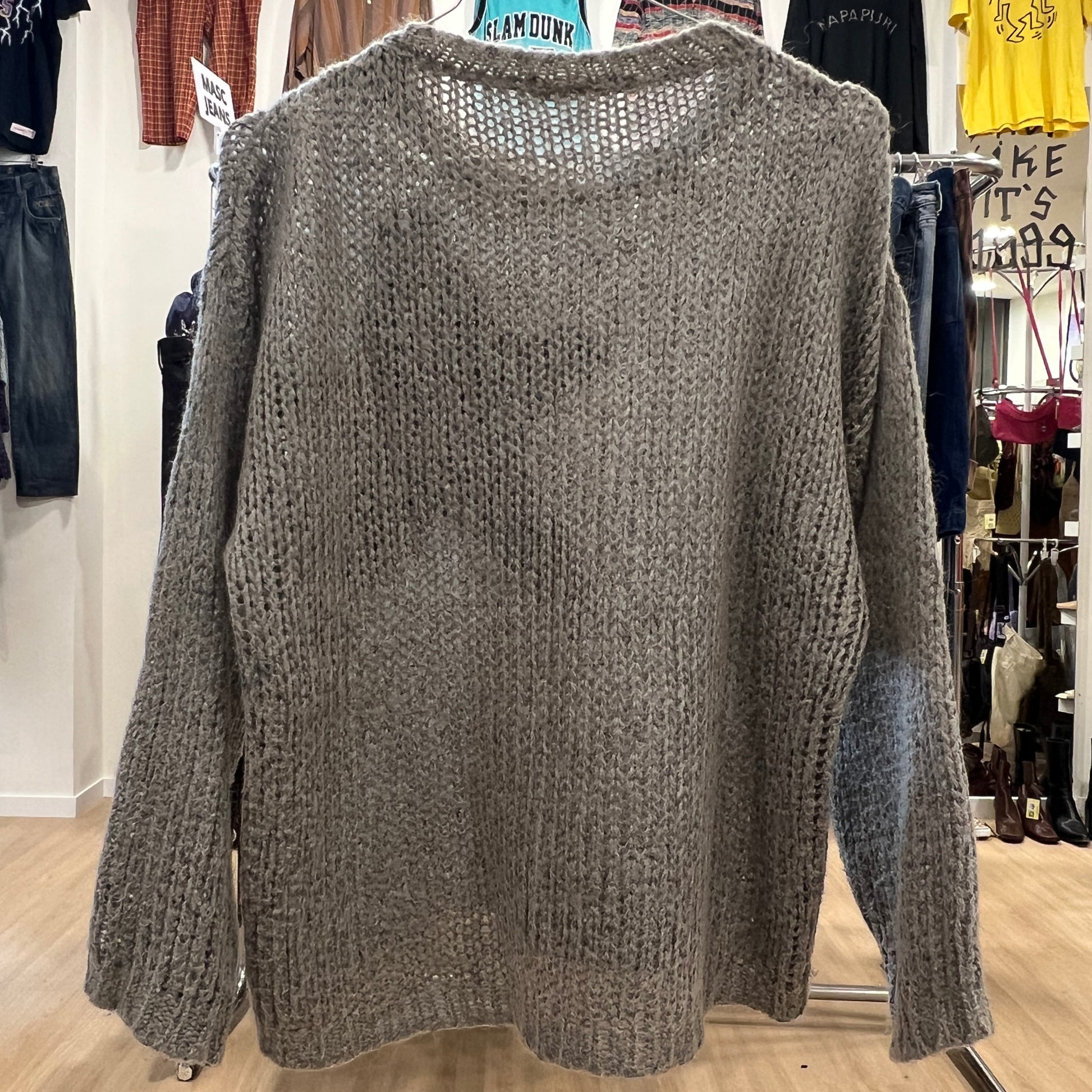 Knitted sweater on a rack in a store setting