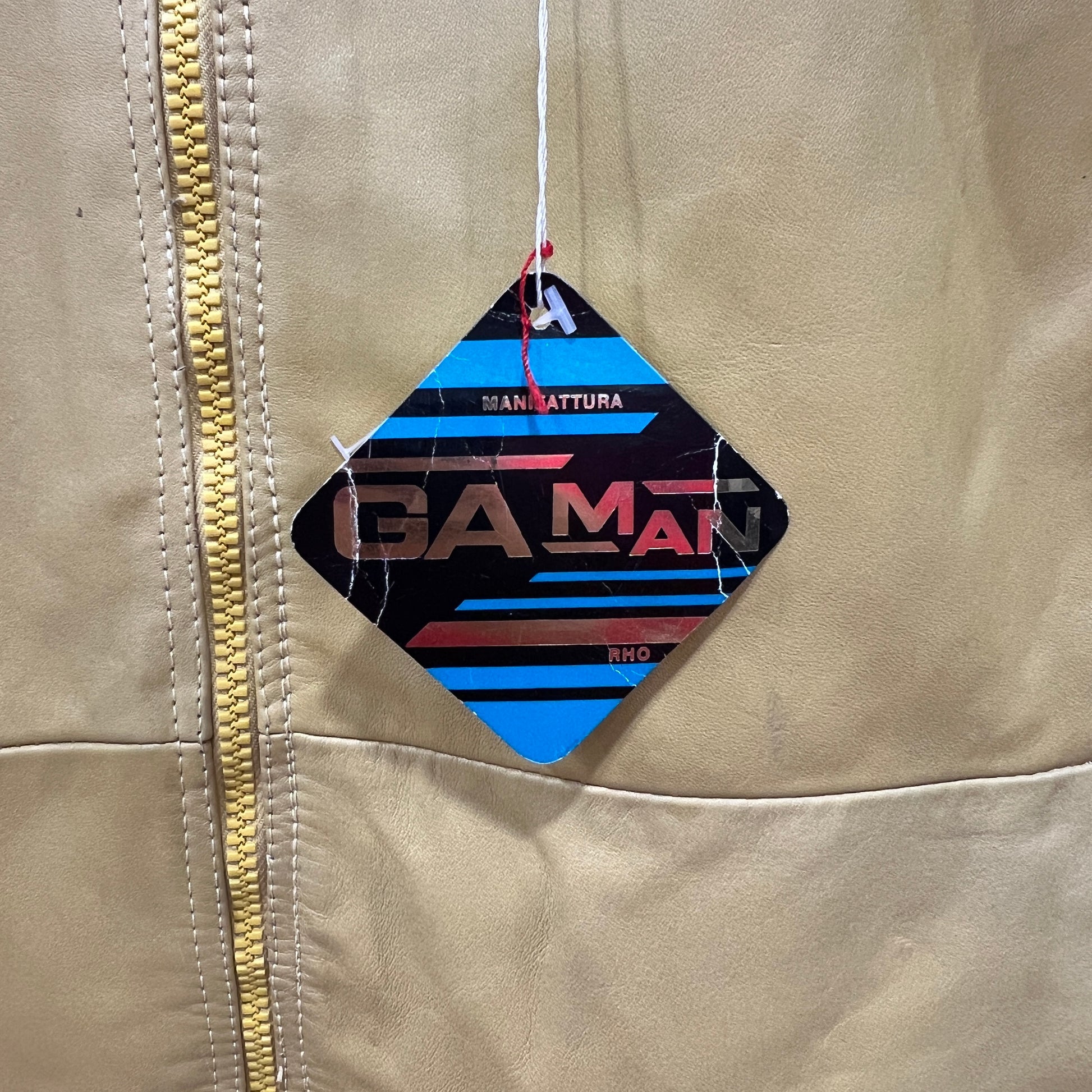 Beige jacket with a colorful 'GAMAN' logo on the chest area